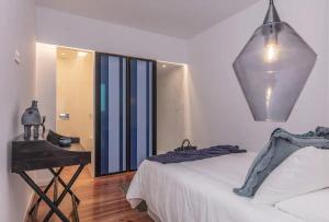 a bedroom with a white bed and a mirror at Luxury Beato Trendy Location in Lisbon