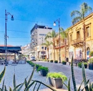 a street in a city with buildings and plants at Kareem flat in Larnaca