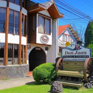 una señal frente a un edificio con una señal de no saltar en Hostal Y Cabañas Don Juan en Villarrica