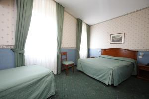 Postel nebo postele na pokoji v ubytování Hotel Adriatic