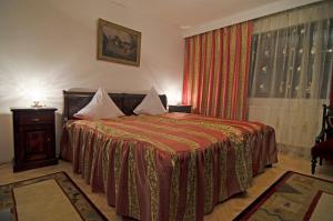 a hotel room with a bed and a window at Casa Lucretia in Vama