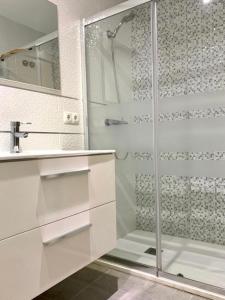 een witte badkamer met een douche en een wastafel bij UIM Mediterraneo Casita Palancia Wifi in Puerto de Sagunto