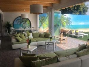 a living room with couches and tables and a large mural at Lady Hamilton B&B in Feletto