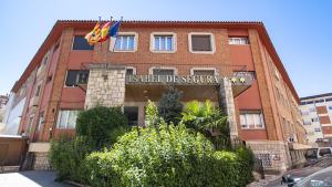 a building with a sign on the front of it at Hotel Isabel de Segura in Teruel