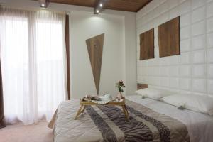 a bedroom with a bed with a table on it at Albergo Diffuso - Il Poggetto tra Urbino & San Marino in Urbino
