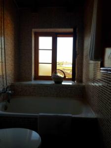 a bath tub in a bathroom with a window at Casa Rural con encanto en Las Arribes Abuelo Román in Masueco +22 photos