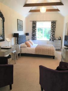 a bedroom with a large bed and a window at Fring House Bed and Breakfast in Seaton