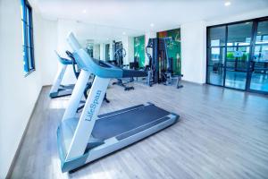 a gym with two treadmills and a treadmill at Hotel Fortunagrande Jember in Jember
