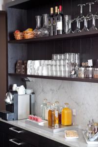 a kitchen with a counter with many bottles of alcohol at Hotel Villan in Gothenburg