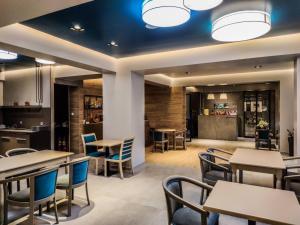 a restaurant with tables and chairs and a bar at Gold Stern in Paralia Katerinis