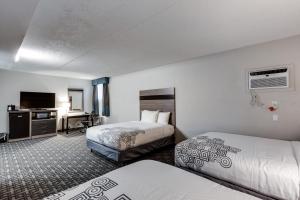Voodi või voodid majutusasutuse Days Inn & Suites by Wyndham Spokane toas