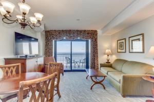 a living room with a couch and a table at Hosteeva Beachfront Condo at Anderson Ocean Club in Myrtle Beach