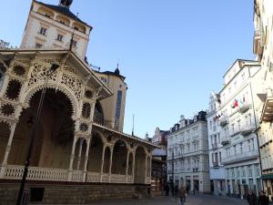 a building in the middle of a street with buildings at 7k - Apartmány Lázeňská in Karlovy Vary