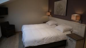 Een bed of bedden in een kamer bij B&B La Vie En Roses