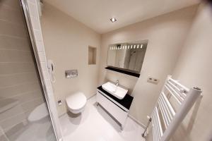 a bathroom with a toilet and a sink and a mirror at Melek Hotels Moda in Istanbul