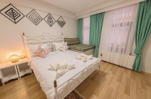a bedroom with a white bed with flowers on it at Duru Istanbul Apart in Istanbul