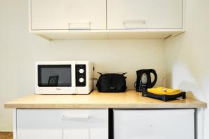 a microwave sitting on top of a kitchen counter at Sintra Bliss A Part in Sintra