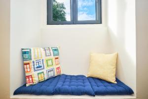 a blue pillow sitting next to a window at Sintra Bliss A Part in Sintra