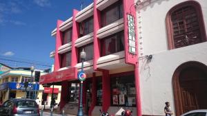 a red and white building on a city street at Flying Donkey in Otavalo