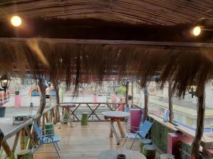 a pavilion with chairs and a table and a picnic table at Flying Donkey in Otavalo