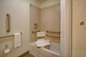 a bathroom with a sink and a bath tub at Candlewood Suites St Clairsville Wheeling Area by IHG in Saint Clairsville