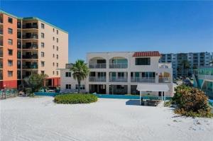 a view of a resort with a pool and buildings at Welcome to the best beach anywhere in St. Pete Beach