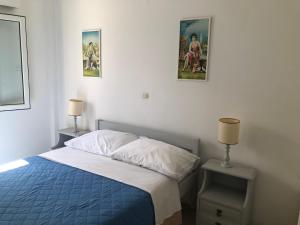 a bedroom with a bed and two pictures on the wall at Margarita Studios in Parikia