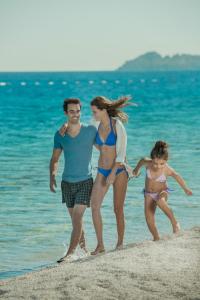 a group of people walking on the beach at Xanadu Island in Akyarlar