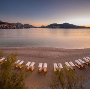 a group of chairs and tables on a beach at Xanadu Island in Akyarlar