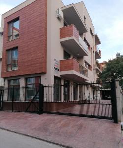 a building with a black fence in front of it at Дунав билдингс in Pleven