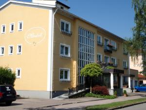 un edificio amarillo con un cartel en el costado en Haus Mirabell, en Bad Füssing
