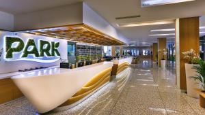 a lobby of a resort with a park sign on the wall at Carine Hotel Park in Bijela