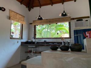 a kitchen with three bowls on top of a counter at Pousada Santa Vila in Serra do Cipo
