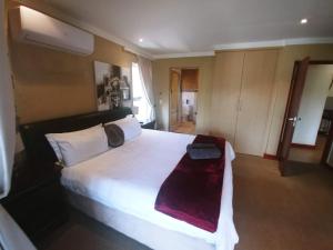 a bedroom with a large white bed in a room at Sands Beach Simbithi Eco Estate Luxury Villa in Ballito