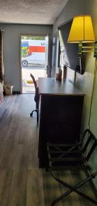 an office with a desk with a lamp and a chair at Palmetto Inn in Estill