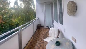 a balcony with a chair and a table and a window at Messeapartment WASHINGTON in Hannover