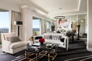 a living room filled with furniture and a large window at Four Seasons Hotel Los Angeles at Beverly Hills in Los Angeles