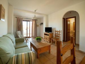 A television and/or entertainment centre at Apartment in Palomares near the Beach
