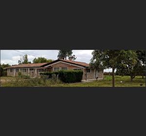 a house with a tree in front of it at Quito Eco Lodge Airport - B&B in Tababela