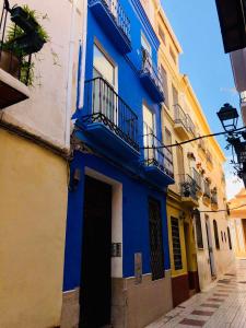a blue and yellow building on a street at Cheap Studios Malaga Center in Málaga