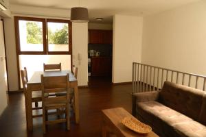 a living room with a table and a couch at Patio del Bastion in Colonia del Sacramento