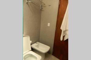 a bathroom with a toilet and a sink at Patio del Bastion in Colonia del Sacramento +5 photos