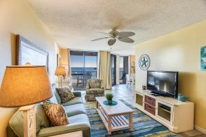 a living room with a couch and a tv at Phoenix 6 Unit 802 in Orange Beach