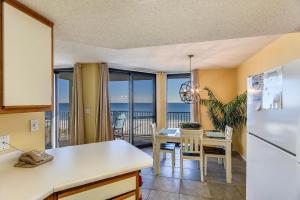a kitchen and dining room with a view of the ocean at Phoenix 6 Unit 802 in Orange Beach