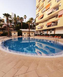 a large swimming pool in front of a building at Cristianos in Los Cristianos