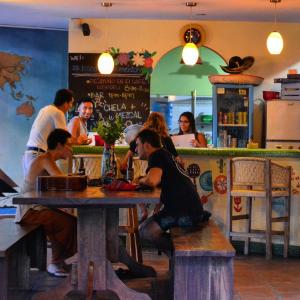 a group of people sitting at a table in a restaurant at Casa Losodeli & Coworking- Adults Only in Puerto Escondido