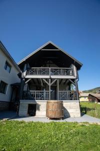 a large house with a wooden barrel in front of it at GARAGE in Yaremche
