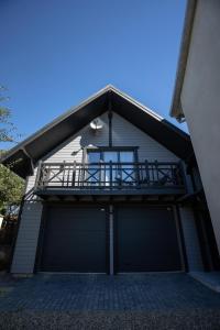 a house with two garage doors and a balcony at GARAGE in Yaremche