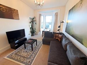 a living room with a couch and a flat screen tv at Dumbarton Hillview in Dumbarton