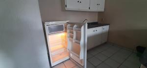an empty refrigerator with its door open in a kitchen at Hotel San Miguel in Autlán de Navarro